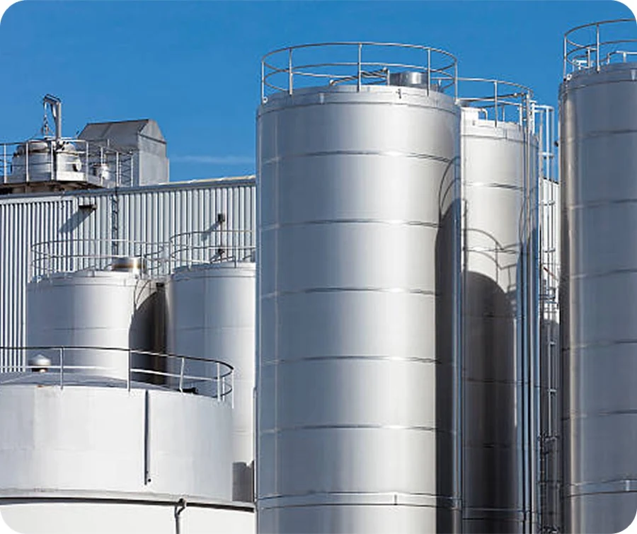 Stainless steel process tanks against an open sky
